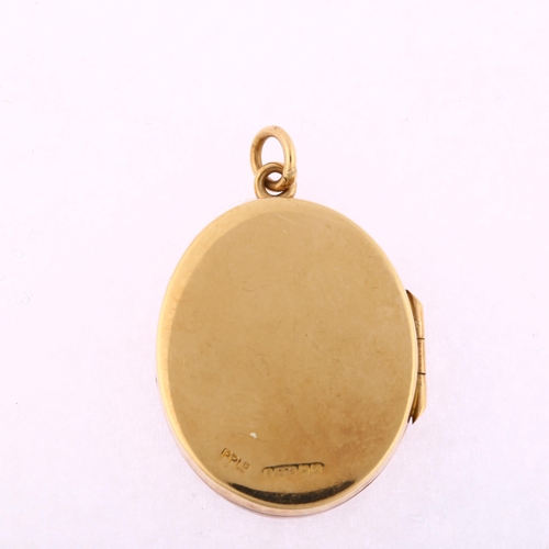 1181 - A late 20th century 9ct gold photo locket pendant, oval form with engraved foliate decoration, maker... 