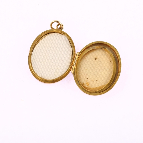 1181 - A late 20th century 9ct gold photo locket pendant, oval form with engraved foliate decoration, maker... 