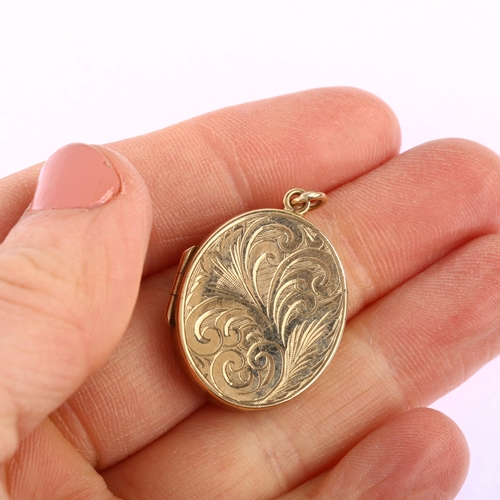 1181 - A late 20th century 9ct gold photo locket pendant, oval form with engraved foliate decoration, maker... 