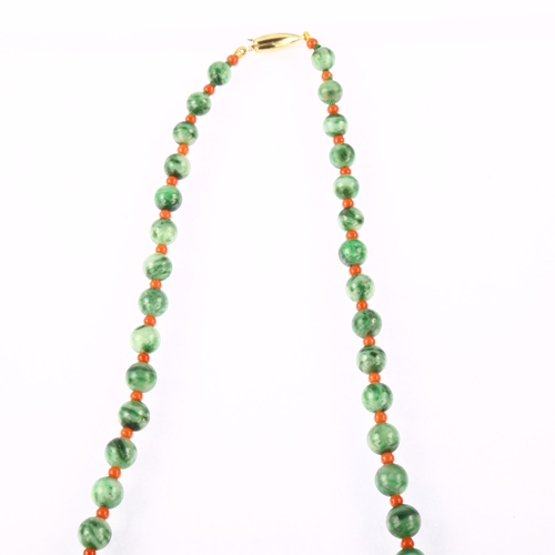 1200 - A graduated single-strand jadeite and coral bead necklace, with 18ct gold barrel clasp, beads rangin... 