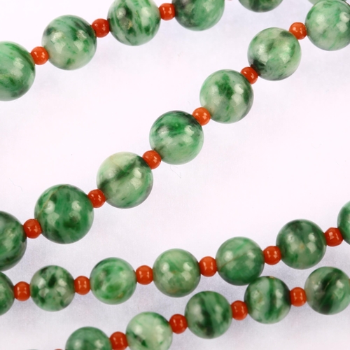 1200 - A graduated single-strand jadeite and coral bead necklace, with 18ct gold barrel clasp, beads rangin... 