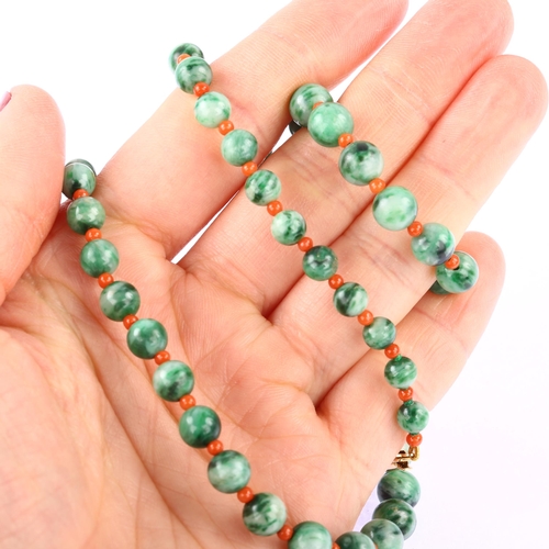 1200 - A graduated single-strand jadeite and coral bead necklace, with 18ct gold barrel clasp, beads rangin... 