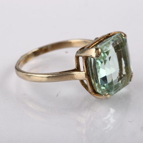 1210 - A solitaire aquamarine ring, unmarked white metal settings with square step-cut aquamarine, aquamari... 