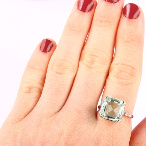 1210 - A solitaire aquamarine ring, unmarked white metal settings with square step-cut aquamarine, aquamari... 