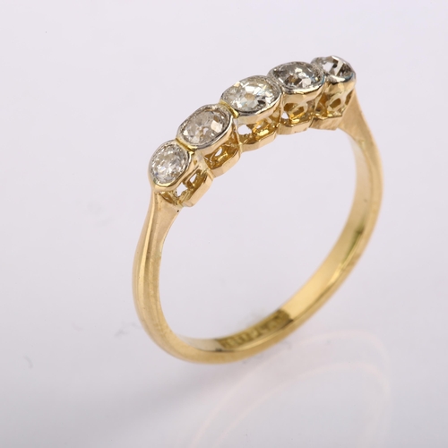 1229 - An 18ct gold graduated five stone diamond ring, bezel set with old-cut diamonds, total diamond conte... 