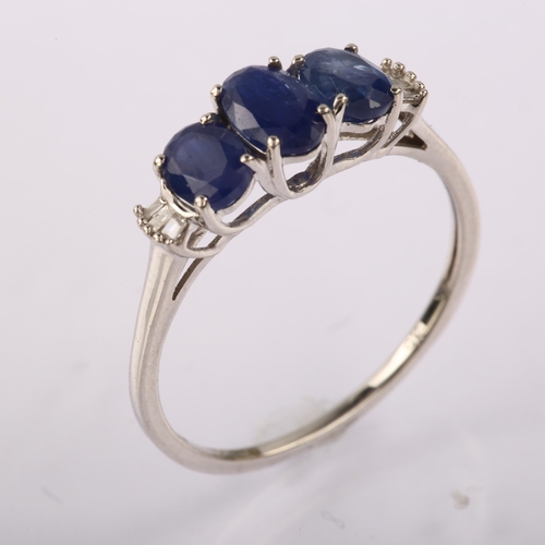 1272 - A modern 9ct white gold sapphire and diamond dress ring, set with oval mixed-cut sapphire and baguet... 