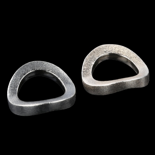 1314 - HANS HENRIK NYGAARD - a pair of Danish modernist oxidised and gilded sterling silver wave band rings... 