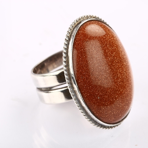 1317 - A Danish modernist sterling silver goldstone panel ring, with double shank, set with oval cabochon g... 