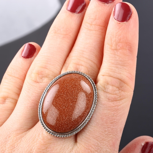 1317 - A Danish modernist sterling silver goldstone panel ring, with double shank, set with oval cabochon g... 