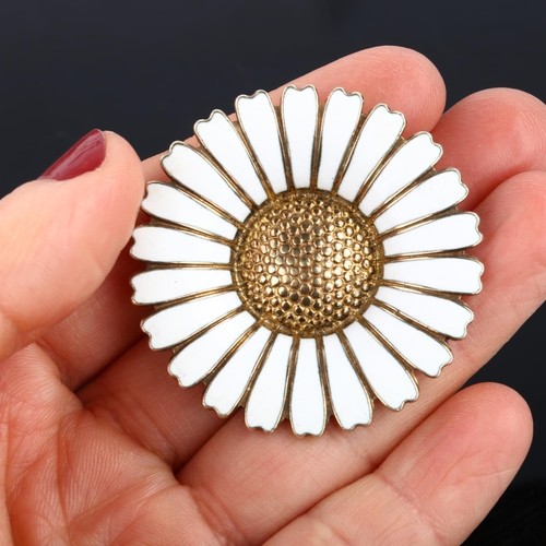 1320 - BERNHARD HERTZ - a Danish vermeil sterling silver and white enamel daisy pattern brooch, diameter 43... 