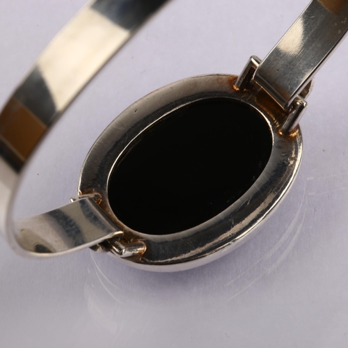 1334 - HERMANN SIERSBOL - a Danish modernist sterling silver and black onyx torque bangle, setting height 2... 