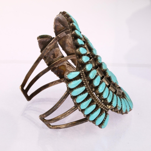 1345 - A large Native American Navajo sterling silver turquoise cuff bracelet, setting height 76.4mm, inter... 