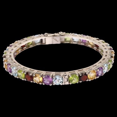 1348 - A modern Continental silver gem set hinged bangle, gemstones include garnet amethyst peridot citrine... 