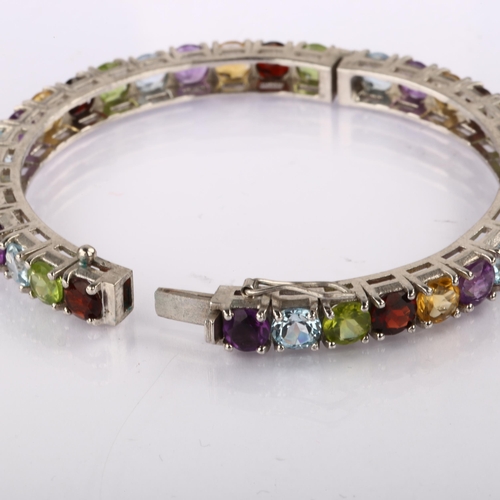 1348 - A modern Continental silver gem set hinged bangle, gemstones include garnet amethyst peridot citrine... 