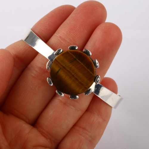 1370 - ALTON - a Swedish modernist sterling silver and tigers eye torque bangle, setting diameter 24.2mm, c... 