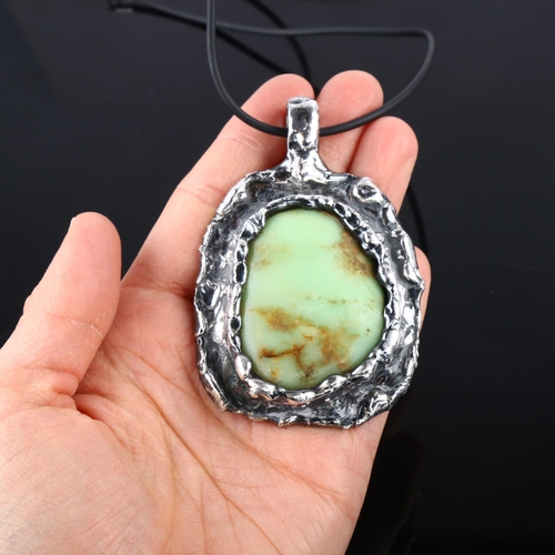 1384 - A large brutalist chrysoprase abstract pendant necklace, unmarked white metal settings with rubber c... 