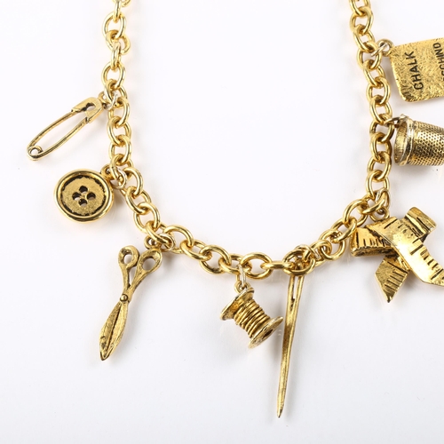 1411 - MOSCHINO - a Vintage gold plated tailor's sewing tools charm necklace, length 40cm, boxed