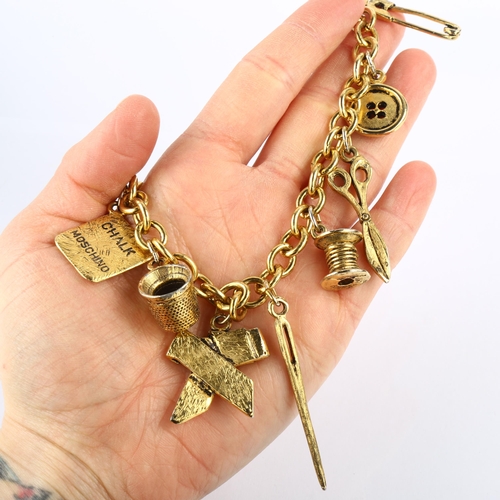 1411 - MOSCHINO - a Vintage gold plated tailor's sewing tools charm necklace, length 40cm, boxed