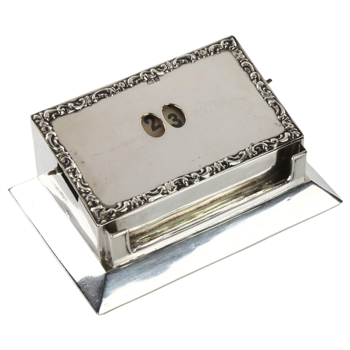 1468 - An Edwardian silver perpetual desk calendar, rectangular form with date windows and relief embossed ... 