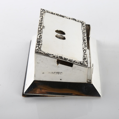 1468 - An Edwardian silver perpetual desk calendar, rectangular form with date windows and relief embossed ... 