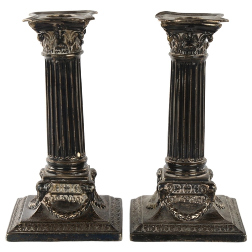 1469 - A pair of Victorian silver Corinthian column table candlesticks, with ram's head swag bases and remo... 