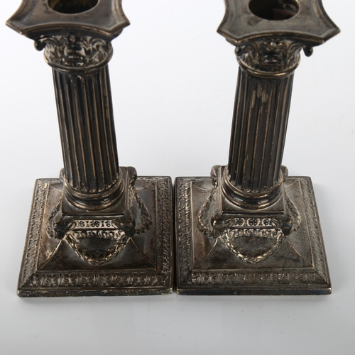 1469 - A pair of Victorian silver Corinthian column table candlesticks, with ram's head swag bases and remo... 