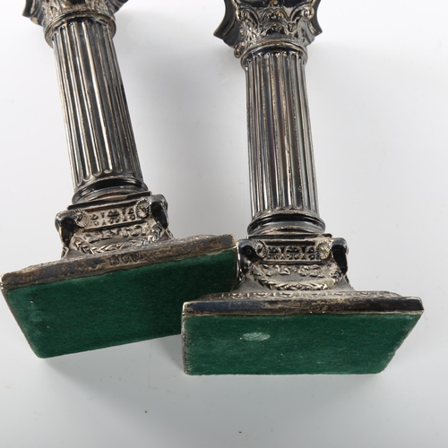 1469 - A pair of Victorian silver Corinthian column table candlesticks, with ram's head swag bases and remo... 