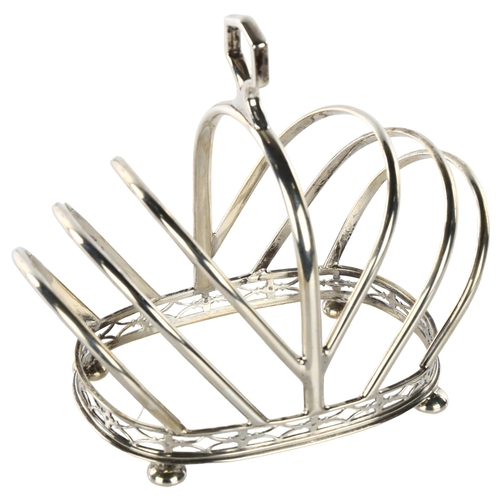 1488 - An Art Deco George V silver 7-bar toast rack, crown form with pierced gallery and bun feet, by Docke... 