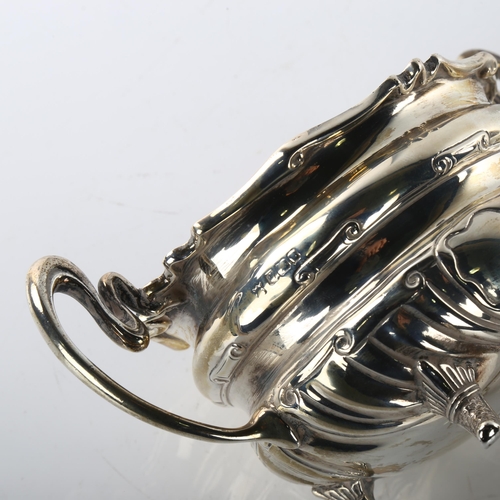 1489 - An early 20th century silver matching 2-handled sugar bowl and cream jug, waisted form with relief e... 