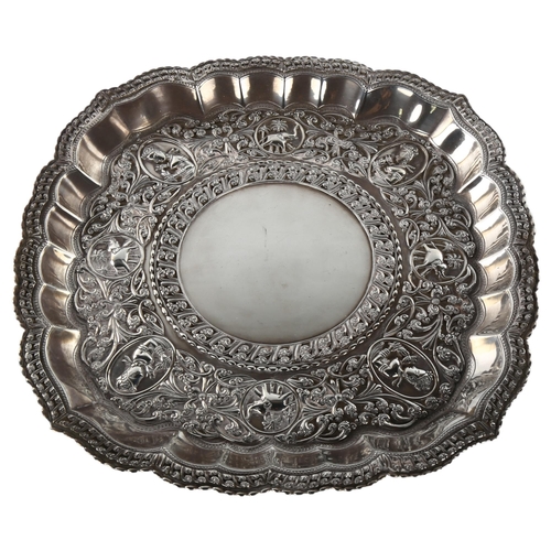 1491 - A large early 20th century Sri Lankan silver presentation salver, circular lobed form with applied f... 