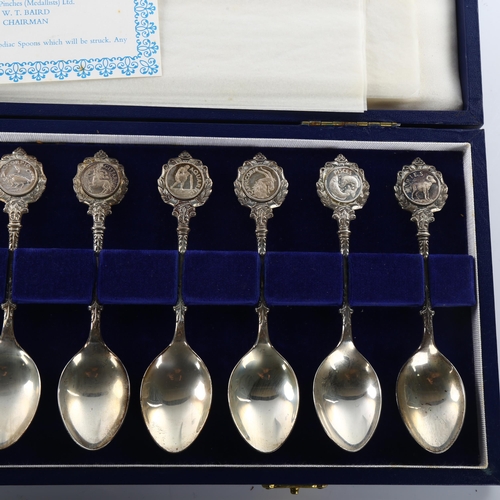 1492 - A set of 12 Elizabeth II silver Zodiac teaspoons, sculpted by David Cornell, by John Pinches Ltd, ha... 