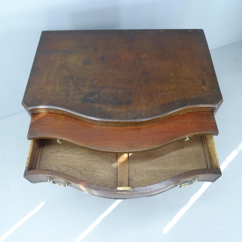 2026 - A Georgian mahogany chest of serpentine form, with four long drawers and brushing slide. 87x84x56cm