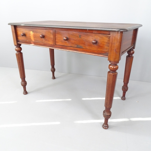 2027 - A Victorian mahogany writing table, with two frieze drawers and raised on octagonal legs. 107x75x59c... 