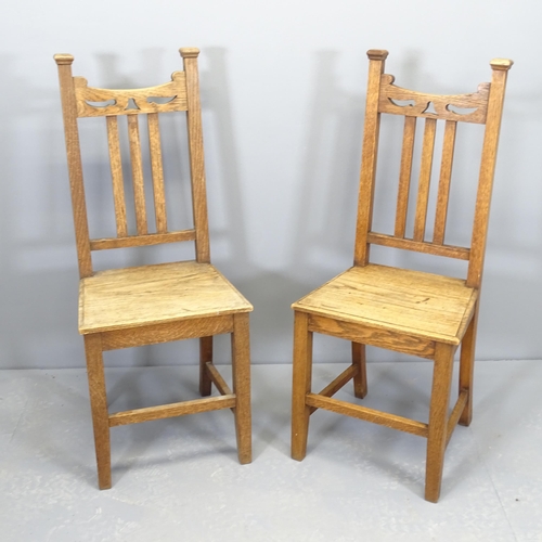 2507 - A pair of Arts & Crafts style oak hall chairs with panelled seats.