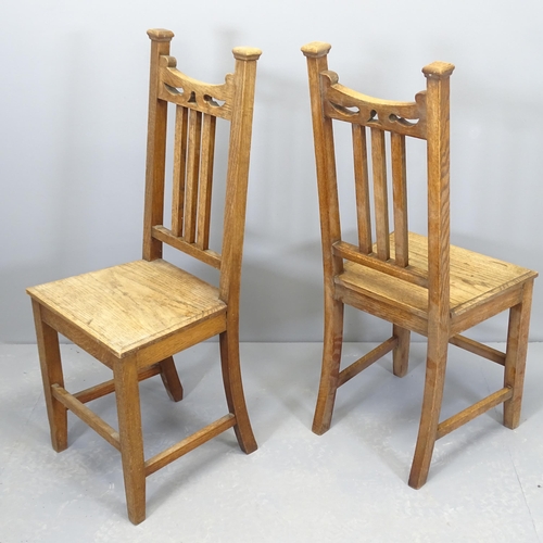 2507 - A pair of Arts & Crafts style oak hall chairs with panelled seats.