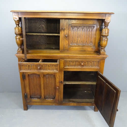 2512 - A 1920s two-section court cupboard, with linenfold carved decoration. 122x145x46cm.