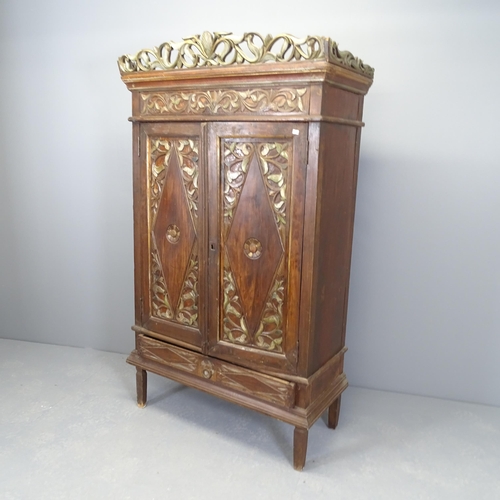 2517 - An Indonesian hardwood two door cupboard, with single drawer to base and chip-carved decoration. 94x... 