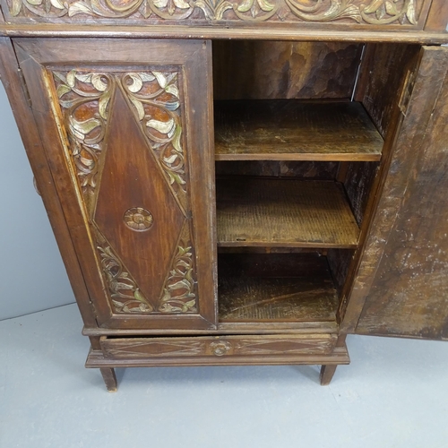 2517 - An Indonesian hardwood two door cupboard, with single drawer to base and chip-carved decoration. 94x... 