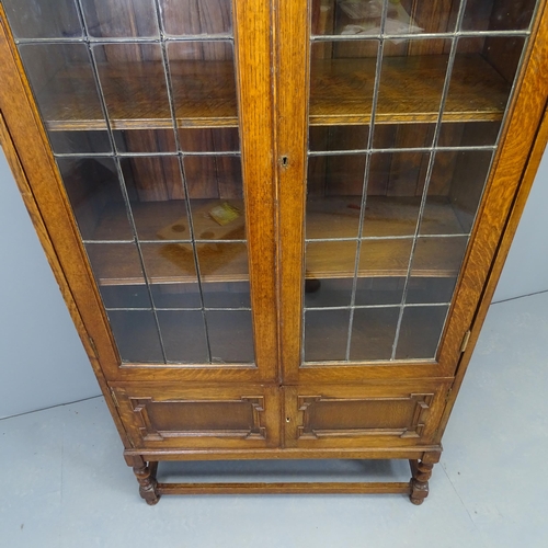 2519 - A large Edwardian oak geometric display bookcase, with two leadlight glazed doors revealing three ad... 