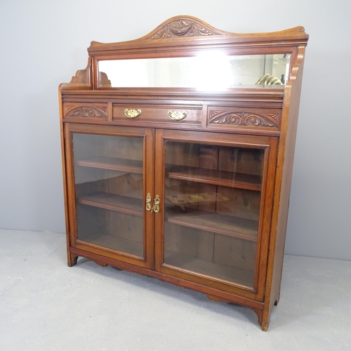 2521 - A Victorian Arts & Crafts two door bookcase, with raised mirrored back, single frieze drawer and thr... 