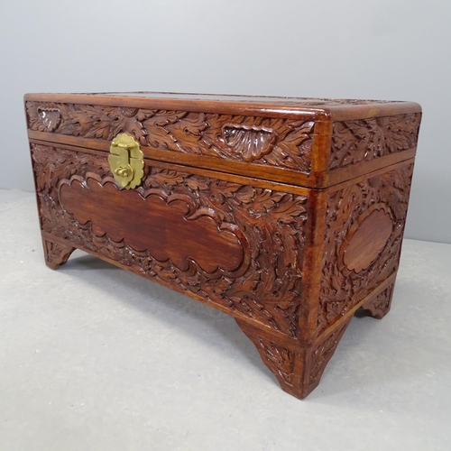 2528 - A Chinese camphorwood blanket box, with carved decoration. 80x45x39cm