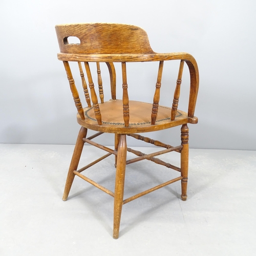 2547 - An early 20th century oak and elm bow-arm desk chair.