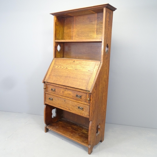 2550 - An Arts and Crafts style bureau bookcase, the fall-front revealing a fitted interior with two drawer... 