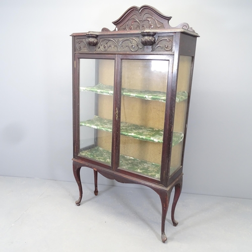 2551 - An antique mahogany two-door display cabinet with three fixed shelves, raised back, carved decoratio... 