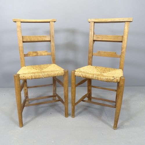 2561 - A pair of rush seated chapel chairs.