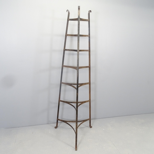 2575 - A cast iron seven-tier pan stand. 58x162cm.