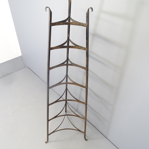 2575 - A cast iron seven-tier pan stand. 58x162cm.