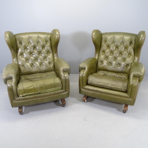 2577 - A pair of Green button-back leather upholstered reclining wing armchairs, with studded decoration. O... 