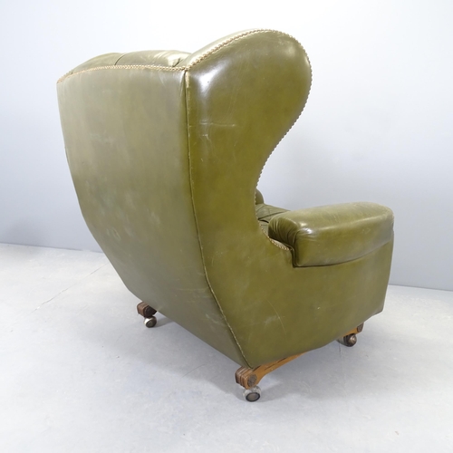 2577 - A pair of Green button-back leather upholstered reclining wing armchairs, with studded decoration. O... 