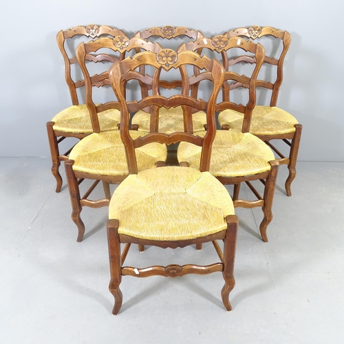 2579 - A set of six French oak rush-seated ladderback dining chairs.